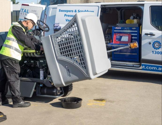 Field Technician Fixing Ride-On Sweeper